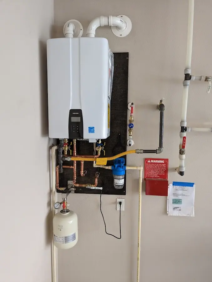 Professional plumber installing copper piping in a Dover home